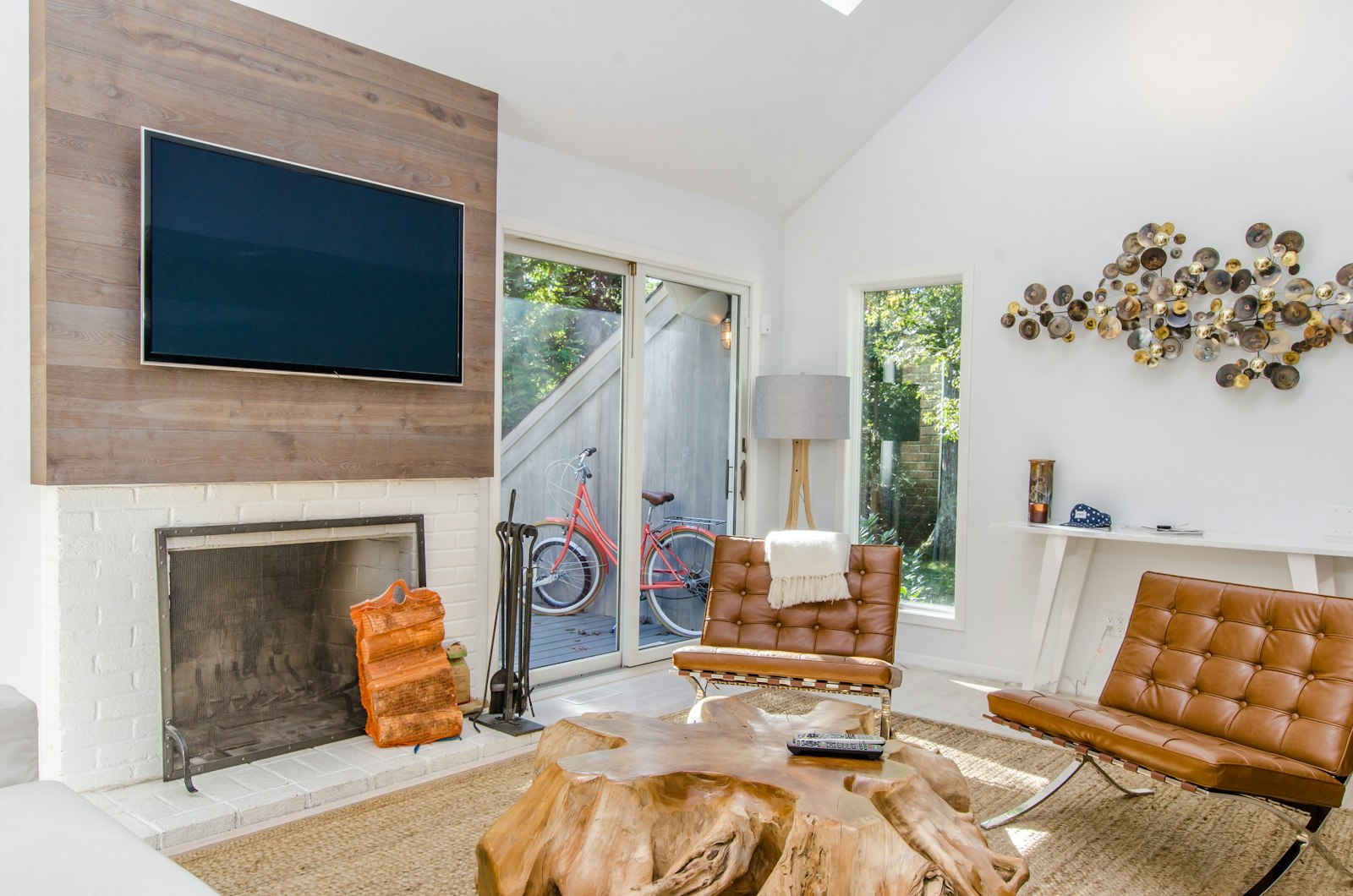 Living room with tufted leather armchairs and a timber stump coffee table