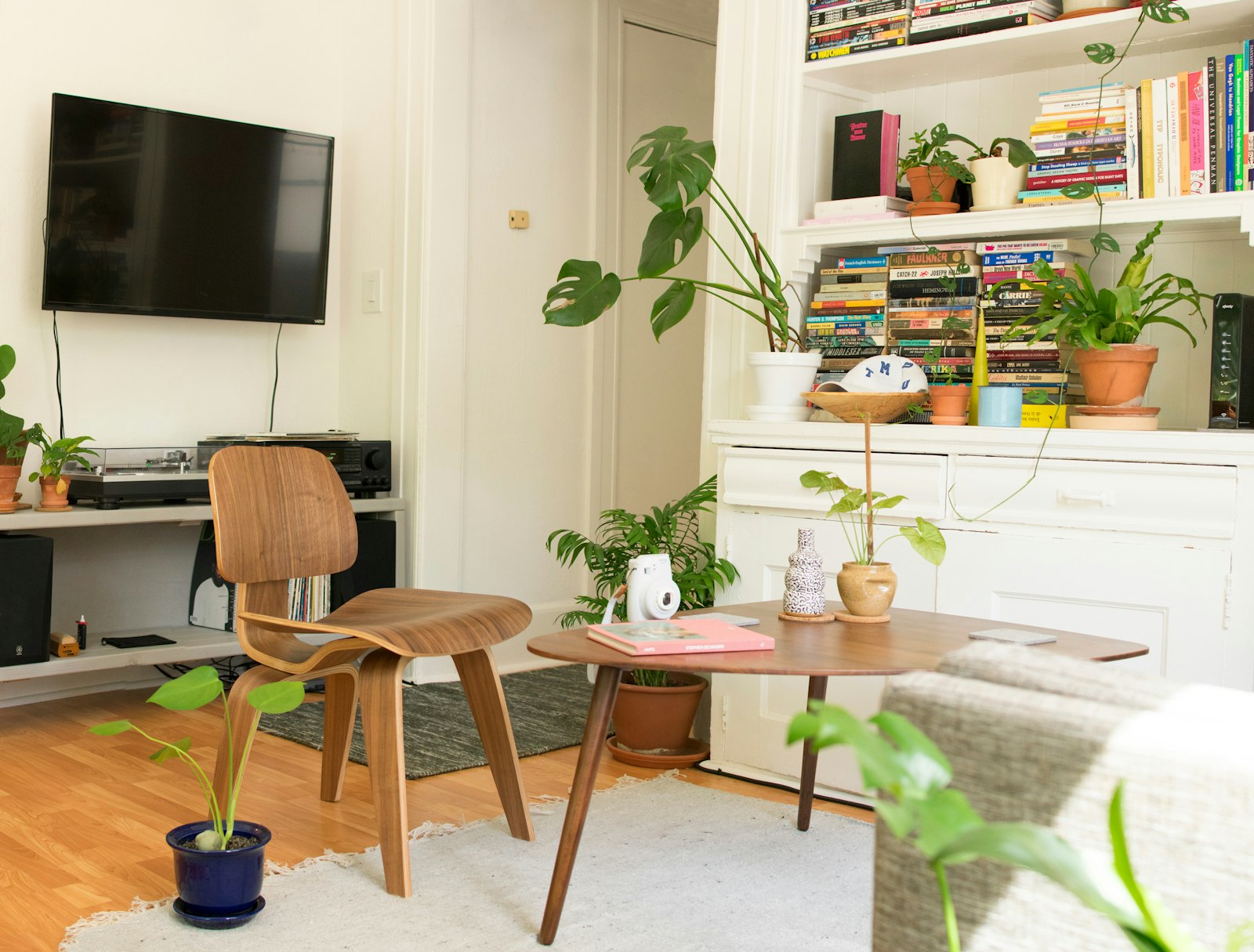 Cosy styled apartment with a timber table, chair and bookshelf